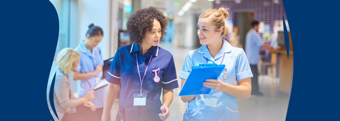 Two nurses walking through hospital