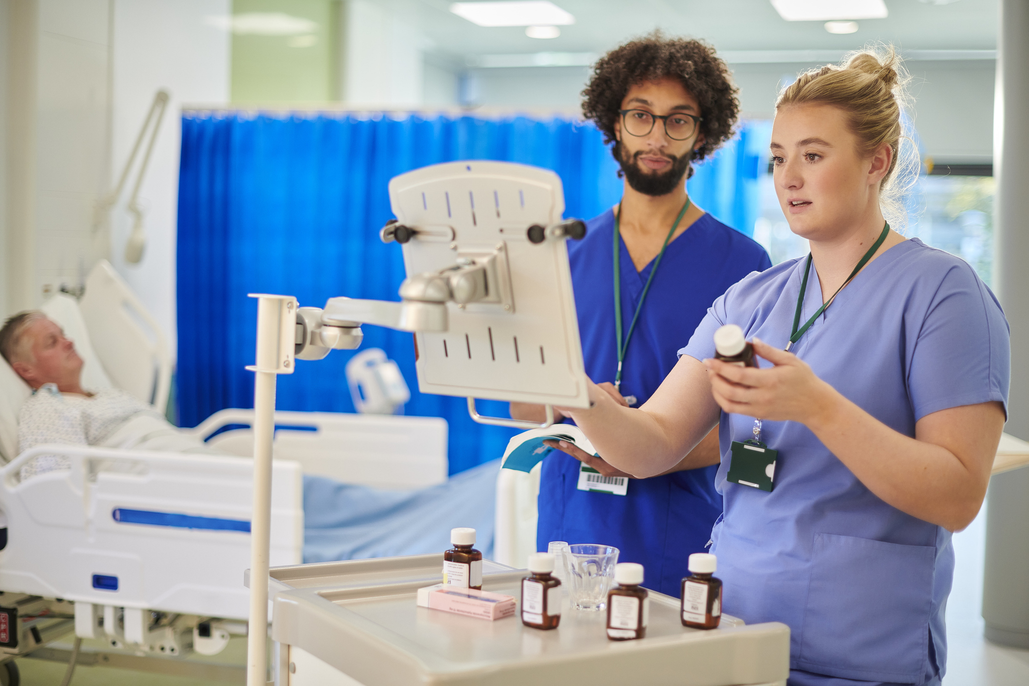 Nursing students using simulation equipment during a hands-on clinical training exercise in a modern skills lab