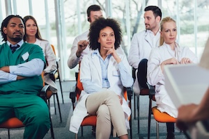 Medical and nurse team listening to a presenter