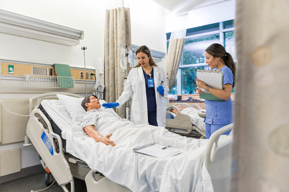 A nurse and a doctor work with a mannequin in a hospital