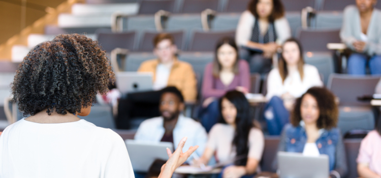 Professor lecturing to students in a classroom