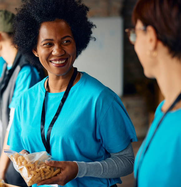 Happy black women talking to her coworker while working